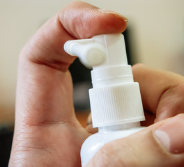 Man with spray inhaler in hand redy to push