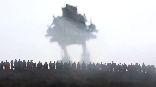 Artwork decoration. Silhouette of giant robot prepare attack crowd at sunset. Horror view of futuristic cyborg going to attack scared people. Selective focus.