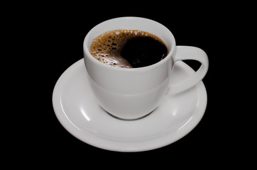 Close up photo of a coffee cup and saucer isolated on black background