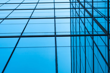 Perspective view of modern futuristic  glass building abstract background. Exterior of office glass building architecture. Reflection in transparent glass of business building. Company glass window.