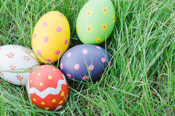 Fototapeta na wymiar Beautiful Easter Multi color egg on garden