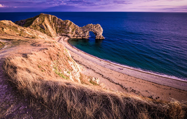 Sunset over Durdle Door - the most famous landmark in Devon England
