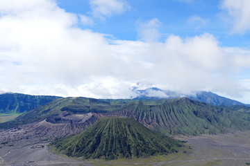 Fototapeta premium The delightful volcanic complex Bromo Tengger Semeru National Park against the background of fascinating views of nature, sky, craters and clouds