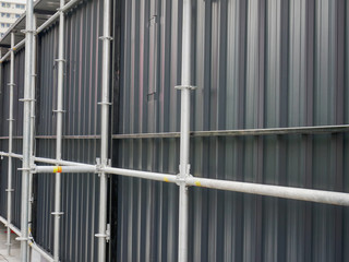 Full Frame Background of Perspective Corrugated Metal Wall and Scaffolding