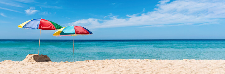Two umbrella on the tropical beach. Summer Holiday Banner