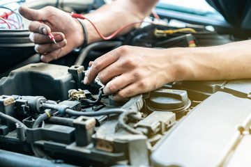 close up tool and hand of People or mechanic car repair during investigate cause of problem (electric system check) or working on automobile gasoline or diesel engine at garage