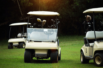 Golfcar in beautiful golf course in the evening golf course with sunshine