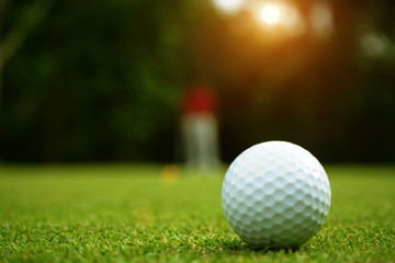 golf ball in beautiful golf course with sunset. Golf ball close up in golf coures at Thailand