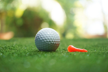 golf ball on green in beautiful golf course with sunset. Golf ball close up in golf coures at Thailand