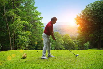 Blurred golfer playing golf in beautiful golf course in the evening golf course with sunshine in...
