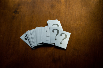 Question mark heap on table concept for confusion, question or solution