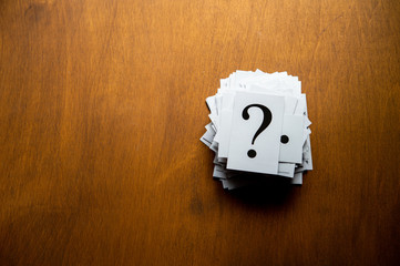 Question mark heap on table concept for confusion, question or solution