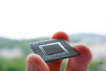 Close up of Semiconductor BGA IC with Man finger hold on it