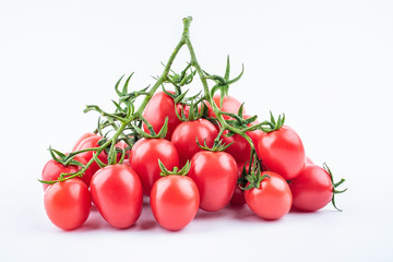 a bunch of red small tomatoes on a white background