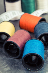 Spools of thread and tape measure using for embroidery and sewing