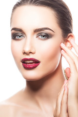 Fototapeta na wymiar Close-up fashion model woman face with red lips make-up, smokey eyes eye shadow, clean skin, blue eyes