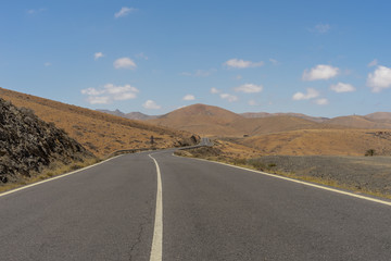 Road in the mountains, on a Canarian island, Fuerteventura with blue sky