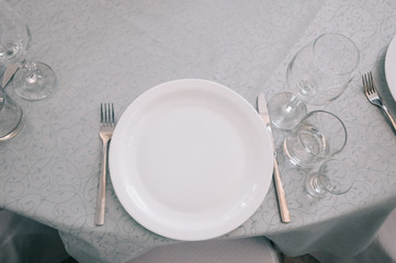Empty white dinner plate on a table