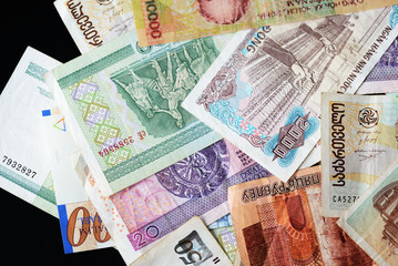 Different countries money background close up. Belarusian rubles, Georgian lari, Polish zloty, Israeli shekels, Vietnamese dongs