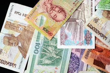 Different countries money background close up. Belarusian rubles, Georgian lari, Polish zloty, Israeli shekels, Vietnamese dongs