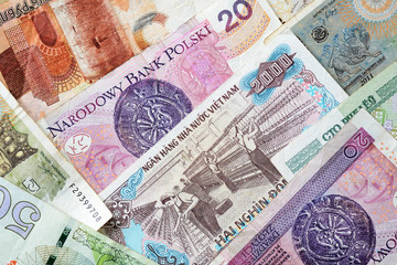 Fototapeta na wymiar Different countries money background close up. Belarusian rubles, Georgian lari, Polish zloty, Israeli shekels, Vietnamese dongs