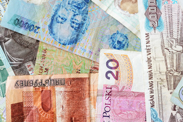 Different countries money background close up. Belarusian rubles, Georgian lari, Polish zloty, Israeli shekels, Vietnamese dongs