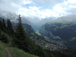 Fototapeta na wymiar Panorama with valley and snow caps on mountain peaks
