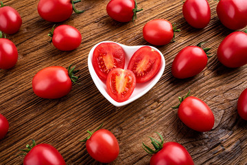 Fresh small tomatoes on a wooden board