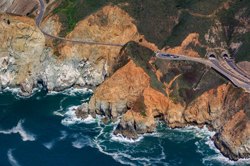 Rugged coastal cliffs by the Devil's Slide tunnel in San Mateo County, Northern California, flying...