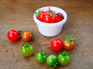 red cherry tomato on wood background