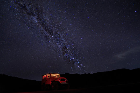 Milky way with red car at Mt.Bromo,East Java,Indonesia. The image may contains noise due to long exposure photography.