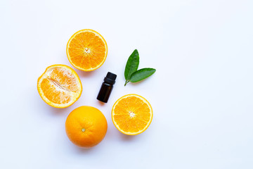 Orange essential oil on white background.