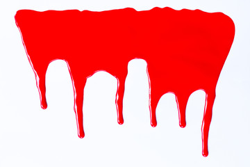 Red paint dripping on a white.