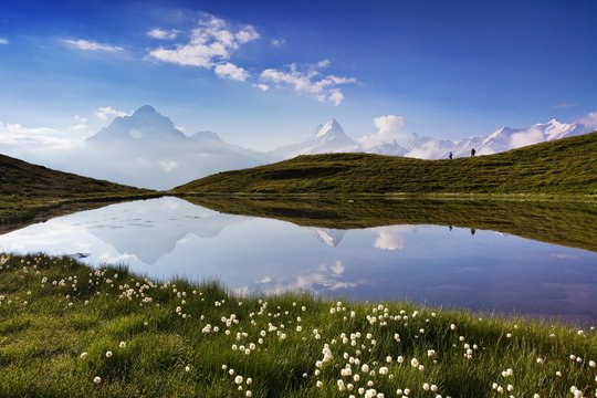 Fantastic morning panorama of Bachalp lake / Bachalpsee, Switzerland. Picturesque autumn sunny day in Swiss alps, Grindelwald, Bernese Oberland, Europe. Beauty of nature concept background. 