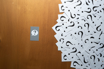 Question mark heap on table concept for confusion, question or solution