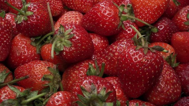 Many Fresh Raw Strawberries Rotating. Healthy Superfood
