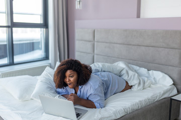 emotional African girl having fun with a computer, gadget and technology concept