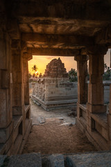 Fototapeta na wymiar achyutaraya temple in hampi karnakata india at sunrise with cloudy sky view vertical from a stone door arch