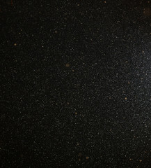 Snow flies in the sky at night as a background