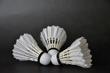 Three shuttlecock with black background.