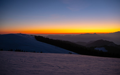 Amazing sunset at Monte Pora ski area in winter season. Landscape to the Italian Alps