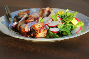 Barbecue meat. Grilled pork skewers with salad on plate.