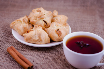 Apple patties on a background of burlap with coffee and cinnamon stick