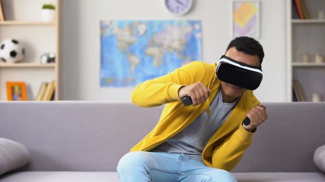 African-American male teenager playing video game in VR headset, imagination