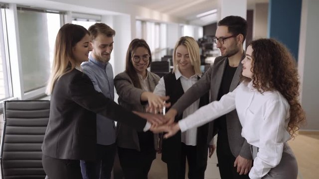 Successful team. Many hands holding together and rise it up