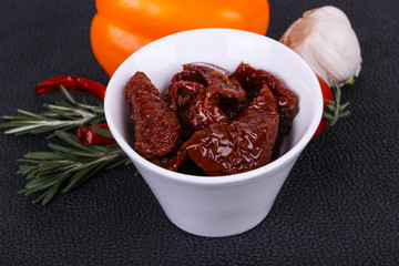 Dried tomatoes in the bowl with olive oil