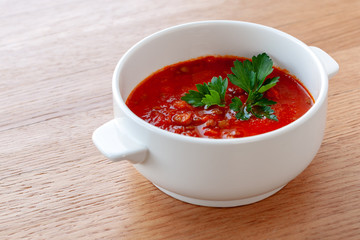 Tomato-lentil soup, decorated with herbs. Ingredients: tomatoes in their own juice, lentils, onions, spices.