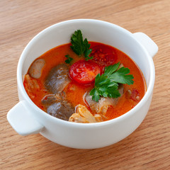 Vegetarian soup Tom Yam with coconut milk, mushrooms and cherry tomatoes. Square format.