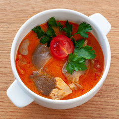 Vegetarian soup Tom Yam with coconut milk, mushrooms and cherry tomatoes. Square format.