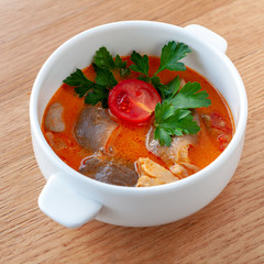 Vegetarian soup Tom Yam with coconut milk, mushrooms and cherry tomatoes. Square format.